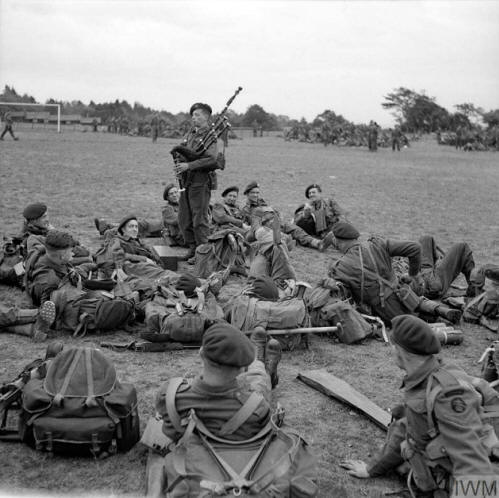 Imperial War Museum photo showing men of 45 (RM) Commando, 1st Special Service Brigade with piper, Bill Millin, entertaining them.