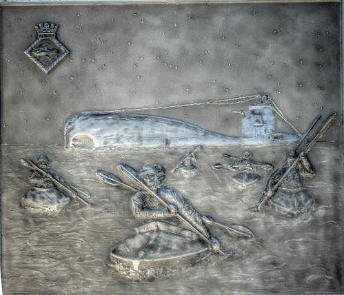 Close up of a panel from the memorial a Le Verdon depicting the canoes leaving submerine HMS Tuna.