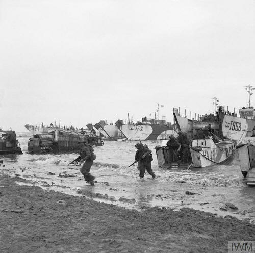 Troops leaving an LCA on to a Normandy landing beach.